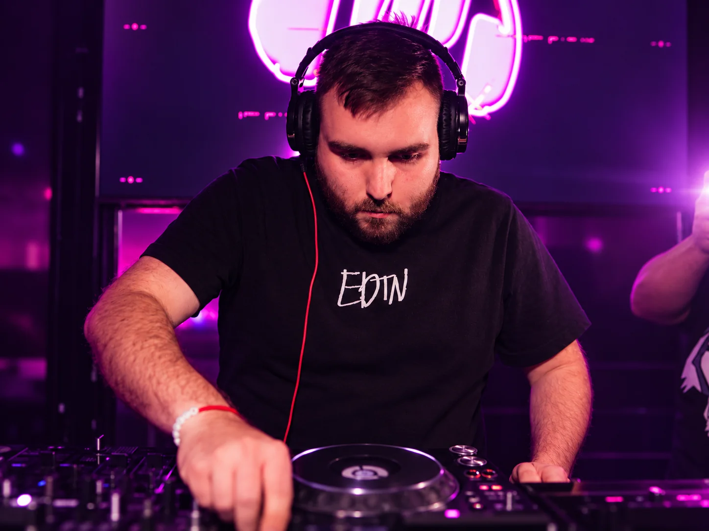 Paulyy Pudd DJing at the decks, photographed at a club